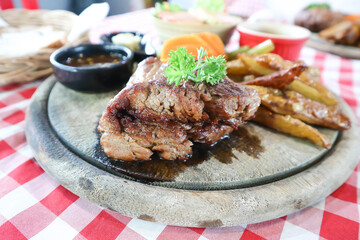 beef steak in gravy sauce or barbecued beef or grilled beef with French fries and vegetable salad