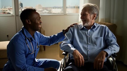 Young doctor smiling and talking with happy senior patient in wheelchair during home visit, showing empathy and providing personalized healthcare