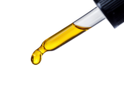 Glass dropper with yellow liquid drop isolated on transparent background