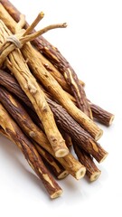 Detail view of licorice roots with brown and white striations on a clean white background