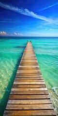 Fototapeta premium Old wooden pier stretching into the calm turquoise waters with gentle waves lapping at its edges