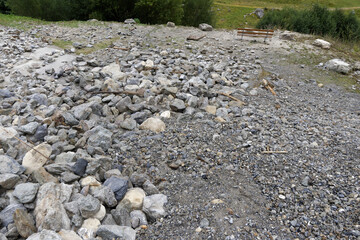 Rockslide in river with big blocks and sand