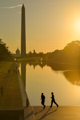 Silhouettes of morning runners and Washington Monument as seen from Lincoln Memorial - Washington,...