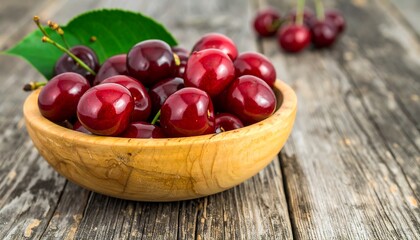 Fresh cherries in wooden bowl on rustic table