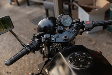 Close-up of motorcycle handlebars speedometer and control instruments from rider perspective
