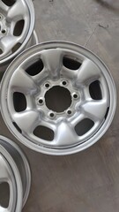 Fototapeta premium A close-up shot of a silver metal car wheel with a multi-spoke design, ready for a vehicle.