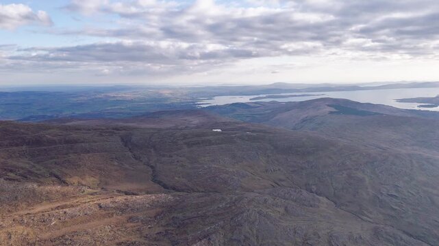 Sweeping views from the rugged terrain of Priest's Leap mountains. This aerial showcases the landscape of County Kerry with Kenmare Bay visible in the distance.