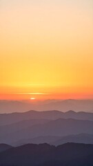 Fototapeta premium Golden sunset over mountain horizon with soft pastel sky gradient
