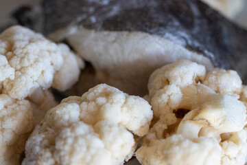 Frozen cauliflower and halibut, healthy food stored in the refrigerator and ready to eat.