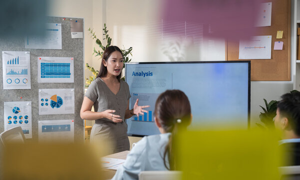 Creative business team meeting to brainstorm innovative ideas for a new venture, showing teamwork, leadership, and startup energy presentation project in a modern office.