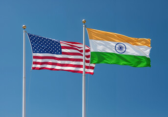 American and Indian flags are waving against a clear blue sky symbolizing unity collaboration