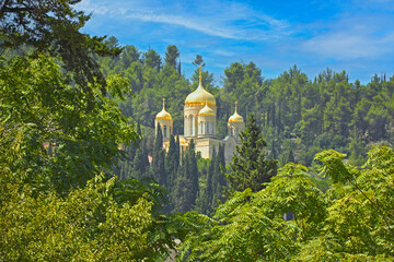 Orthodox church located among wooded hills.
