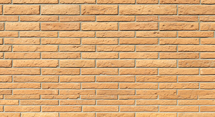 Close up of a weathered tan brick wall with a repeating horizontal pattern creating a textured background for design