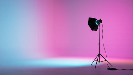 Photography equipment studio backdrop with soft box light and colored gradient lighting