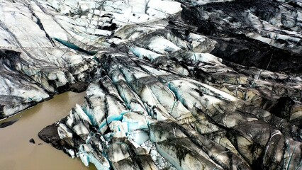 Line of the frozen wall at the front of the Solheimajokull Glacier in Iceland, covered by volcanic ash.