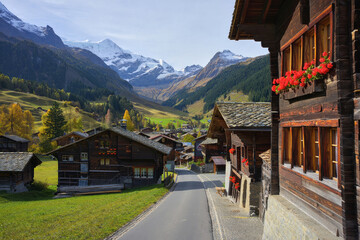 Scenic view of traditional Swiss chalets surrounded by majestic mountains on a clear autumn day Generative AI