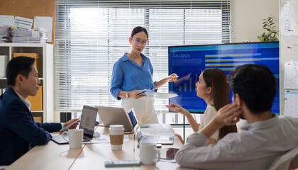 Creative business team meeting to brainstorm innovative ideas for a new venture, showing teamwork, leadership, and startup energy presentation project in a modern office.