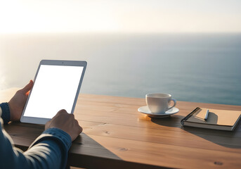 Person Using Tablet with Blank Screen at Outdoor Table with Coffee and Notebook, Overlooking Serene Water at Golden Hour – Remote Work & Digital Lifestyle
