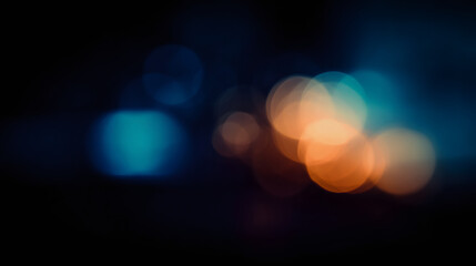 Abstract bokeh light texture with orange and blue circular blurs on dark background. Defocused city night lights for overlay or backdrop.