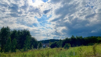 Cloudy Sky Over a Lush Green Landscape