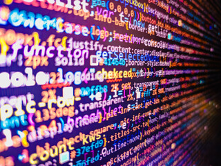 Computer code background. Colorful programming source typed on the screen of the monitor with shallow focus effect. Modern technology and futuristic concept abstract visualization of software. 

