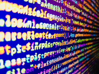 Computer code background. Colorful programming source typed on the screen of the monitor with shallow focus effect. Modern technology and futuristic concept abstract visualization of software. 
