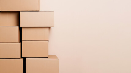 Obraz premium Stack of cardboard boxes against a plain beige background with empty space on the right. Concept of storage, moving, packaging, and shipping logistics.