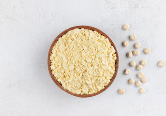 Lupines flour in a wooden bowl on a gray background. Gluten-free, protein-rich food. Top view.
