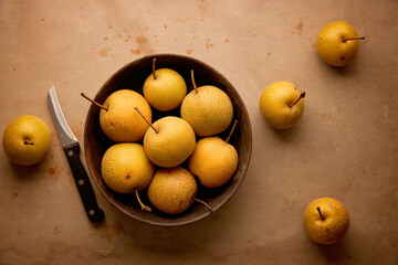 Fresh organic nashi pears in a wooden bowl 