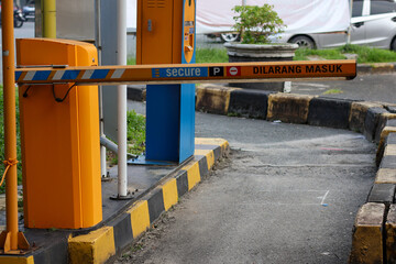 An orange parking lot entrance barrier with a 