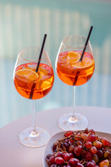 Aperol Spritz cocktails with grapes on table