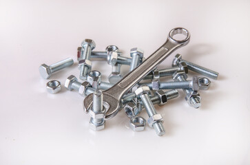 Wrench, bolts and nuts on a white background