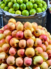 Fresh apples and limes for sale at a local market healthy food and fruit nutrition concept image
