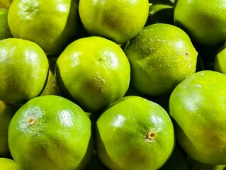 Fresh green limes background close up shot for healthy food and drink concepts and lime recipes ideas