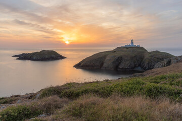 Strumble Head Lighthouse on the Pembrokeshire Coast in Wales at sunset