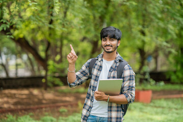Fototapeta premium Young Male College Student With Laptop