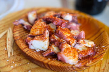 A Cook Serving a Plate of Octopus Outdoors. Concept The atmosphere of a summer festival.