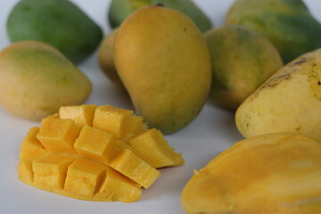 Nayab mangoes, whole and cubed, with vibrant flesh and skin tones. South Asian fruit of summer