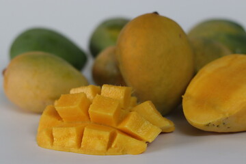 Nayab mangoes, whole and cubed, with vibrant flesh and skin tones. South Asian fruit of summer