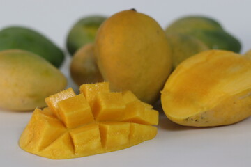 Nayab mangoes, whole and cubed, with vibrant flesh and skin tones. South Asian fruit of summer