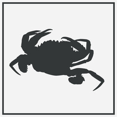a crab silhouette on a light background. The crab has clearly defined claws and legs, and the entire outline is in dark color.