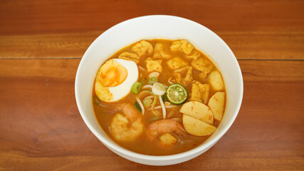 Laksa, creamy spicy soup made with a coconut milk base. Common ingredients include noodle, shrimp, tofu, boiled egg
