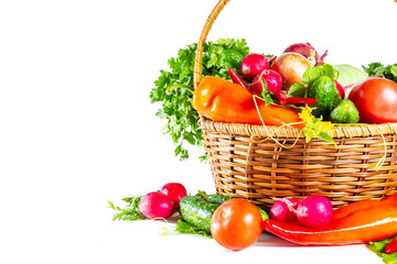Fresh shiny different vegetables in a wicker basket. Isolated on white background.