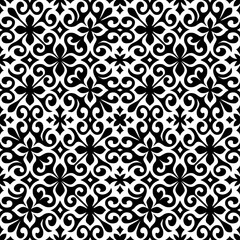 Seamless black and white ornamental pattern with floral and swirl motifs. Elegant decorative background for tiles, textiles, or wallpaper.