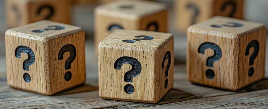 Conceptual wooden blocks marked with question marks, symbolizing curiosity, creativity, design thinking, exploration of ideas, and problem-solving in professional or academic settings
