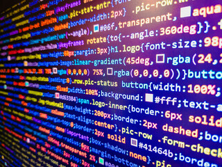 Abstract laptop screen of web developer. Developer working on program codes. Minificated web development javascript code close up in sunset rays