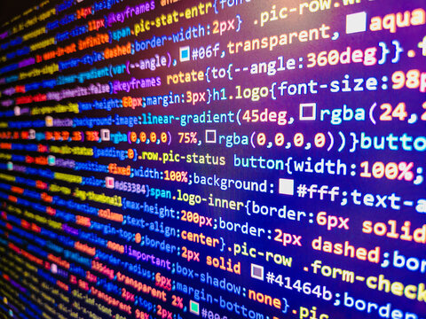 Abstract laptop screen of web developer. Developer working on program codes. Minificated web development javascript code close up in sunset rays