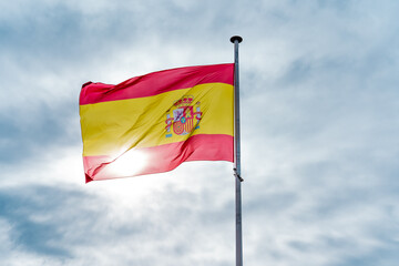 Spanish National Flag Waving in the Sky with Sunlight