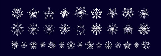 Set of white chalk snow flake drawings of dark blue blackboard. Childish crayon, pencil, pastel whimsical scribbles. Winter Merry Christmas and Happy New Year design elements. Fancy ice frozen symbols