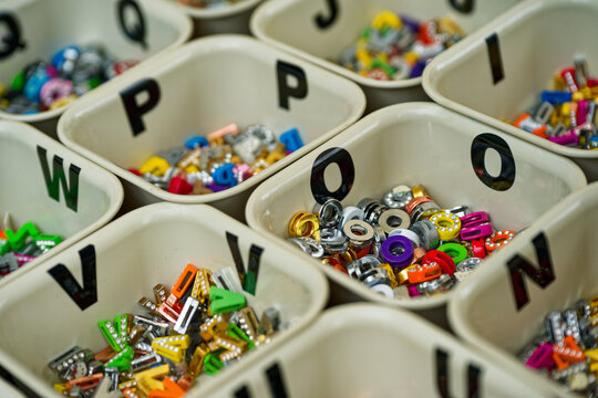 Colorful alphabet bead boxes neatly organized for crafts and jewelry making with letter p o v